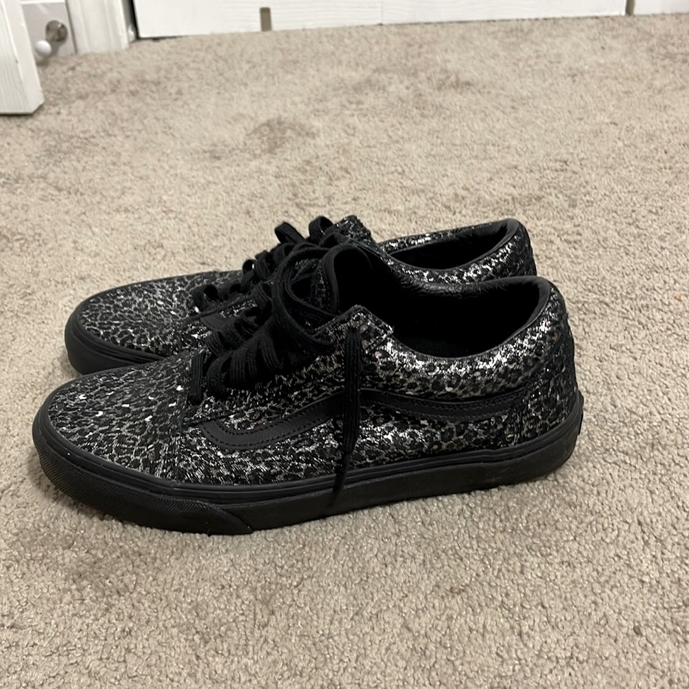 A pair of leopard print vans